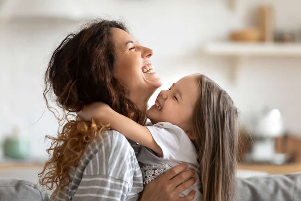 a woman and a child laughing