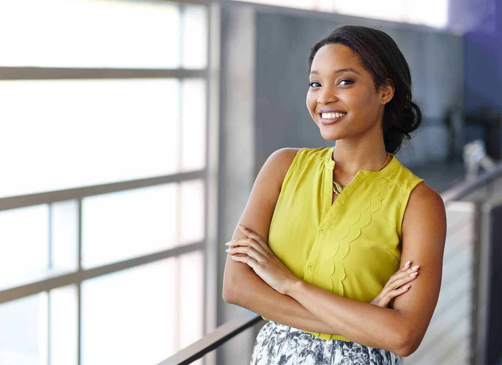 a woman smiling with her arms crossed