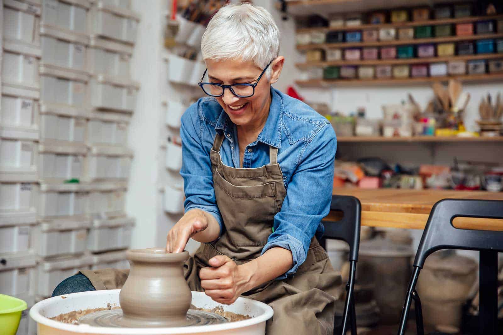 a woman making a vase