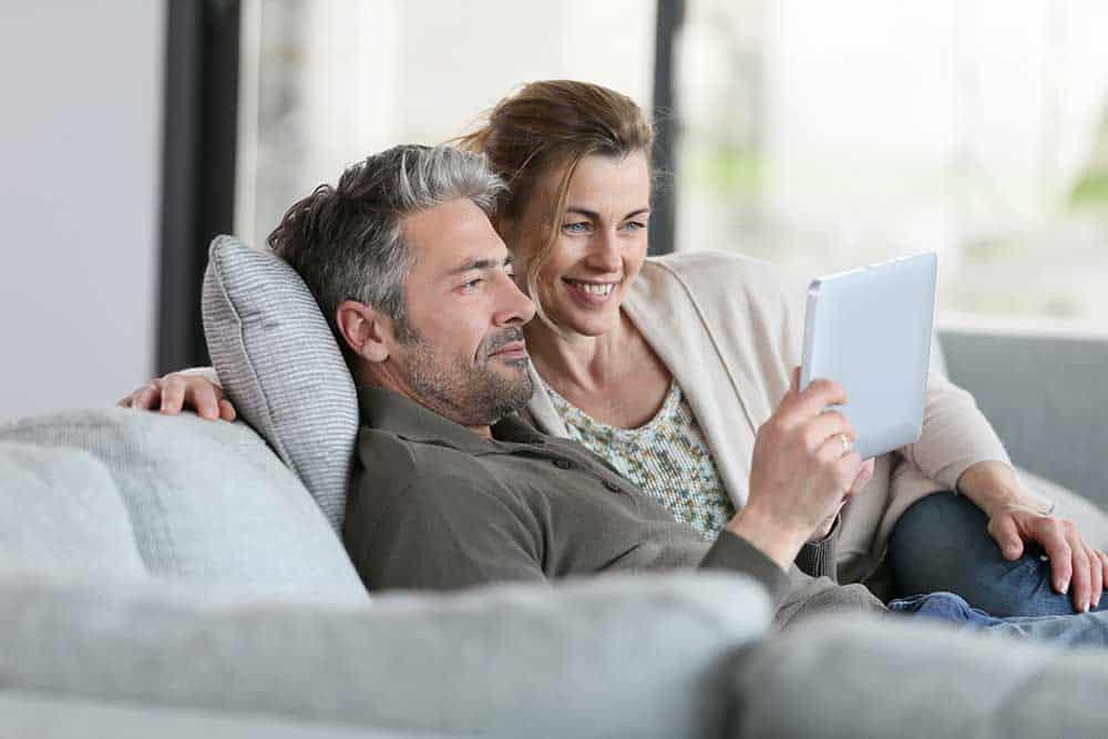 man and woman looking at a tablet - Marion Root Canal Treatment