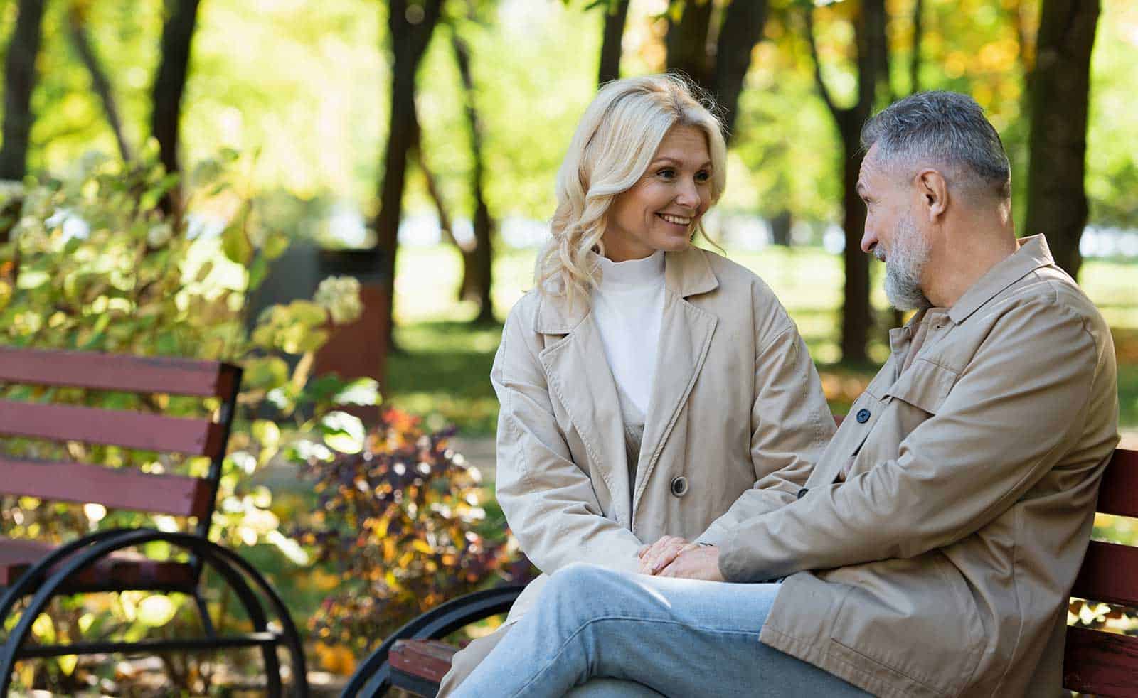 a man and woman sitting on a bench