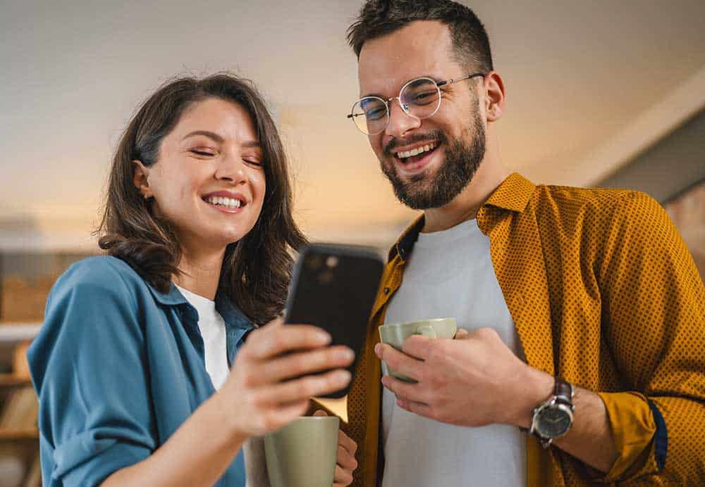 a man and woman looking at a phone